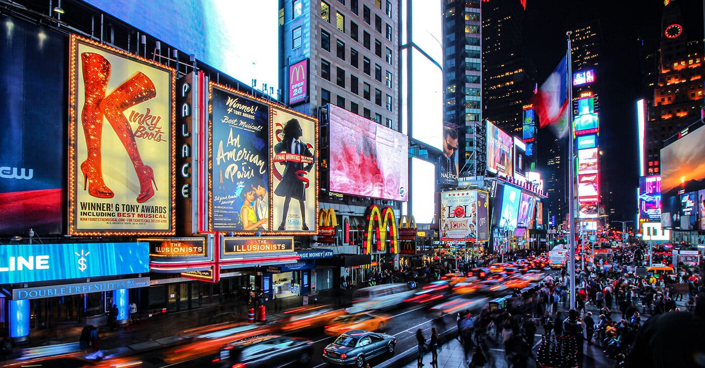A shot of Times Square with blurred cars and crowds